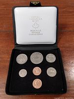 Open case showing seven Canadian coins from 1978 arranged in black velvet holder.