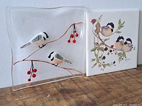 Front view of the beveled glass plate with 3D chickadees and the signed ceramic tile showing illustrated chickadees and berry branches.