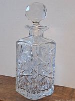 Front view of the heavy crystal decanter showing the detailed cut patterns and facetted stopper.