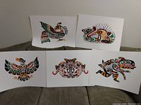 Photo showing five distinct First Nations art prints by John Nelson displayed together.