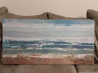 Front view of abstract landscape print on stretched canvas showing layered colors and wood frame.