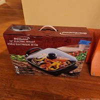 Photo of boxed Brentwood 12-inch electric skillet showing front with handle and product photo.