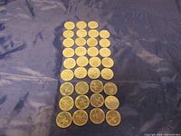 Row arrangement of 37 Canadian quarters featuring RCMP design on dark fabric background.