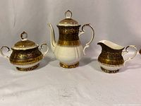 Full set of three pieces: coffee pot, cream pitcher, and sugar bowl displayed against neutral background.