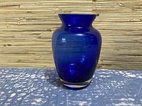Front view of the vintage blue glass vase with clear base showing its full shape and color.
