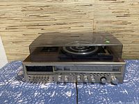 Full view of Lloyd's AM/FM multiplex cassette recorder receiver with record player and clear dust cover closed on top
