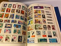 Open album showing assorted Russian postage stamps with various colorful designs and subjects.