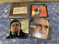 Top view of stacked vinyl records showing album covers by Johnny Cash and Richard Clayderman