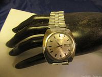 Vintage Seiko men's automatic wristwatch on display, showing full watch face and metal band