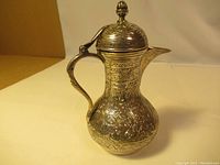 Overall view of the silver coffee pot showing body shape, handle, spout and lid