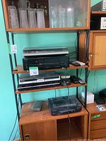 Shelf view showing two turntables, stereo components, DVD player, and phone