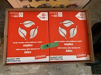 Photo showing two packs of Staples Copy printing paper in original packaging, part of a total of 8 packs