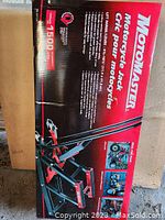 Box of MotoMaster Motorcycle Jack with product information visible.