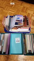 Photo showing multiple folders and boxes filled with assorted blank greeting cards in various sizes and colors