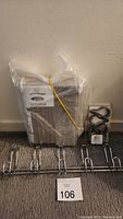 Full lot showing new shower curtain package, metal multi-hook rack, and individual metal shower curtain hooks.