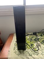 Front view of tall rectangular Holmes air purifier with vented panel showing dust accumulation.
