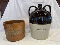 Front view of the two ceramic items side by side, showing jug with Lehn & Fink text and pot with eagle design.