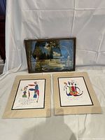 Framed Magic Pool print by Fox displayed with two wrapped StoryPeople prints by Brian Andreas in front against a white backdrop.