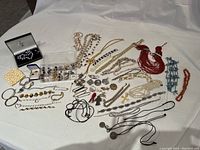 Overview of entire jewelry assortment laid on white cloth