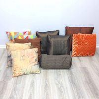 Photo of the collection of 9 cushions including various colors and textures.
