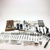 Full layout of cutlery and kitchen utensils displayed on a white background