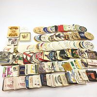 Wide overview photo showing hundreds of coasters in stacks spread out by design and shape