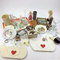 Wide view of all home decor, glassware, plates, figurines, and jewelry boxes arranged on tabletop