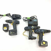 Three Mastercraft cordless drills; one 12V drill with 2 batteries that works, and two 14.4V drills that don't work. Includes two battery chargers.