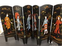 Six-panel wooden folding partition with painted Asian women on black lacquered background