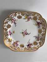 Top view showing overall floral pattern and scalloped edges with gold highlights