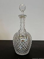 Front view of the vintage crystal decanter showing the diamond cut pattern, stopper, and Sherry label