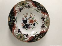 Top view of the entire dish showing the overall floral and decorative pattern with gold trim on white porcelain