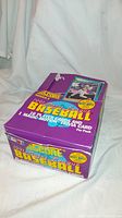 Purple Score box of 1991 Major League Baseball cards with bright yellow lettering and images of baseball players, including a circular sticker about Mickey Mantle.