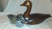 Wood duck decoys front and side view, showing painted and stained wood, detailed feathers, and glass eyes