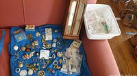 Entire collection laid out on blue cloth with wooden jewelry box visible