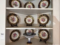 Shelf display showing nine salad plates and one fluted bowl.