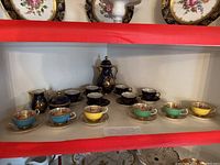 Full display of cobalt set on upper shelf and pastel Paragon cups below.