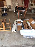 Overall view of lot showing wooden loom components, adjustable stand, cardboard boxes, and plastic bin