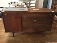 Front view of entire cabinet showing tambour door, hinged door, legs and overall condition