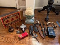 Overview of lot showing assorted vintage tools including shoe forms, knives, decorative pineapple item, bellows, and various boxes and tools.