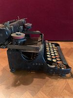Side view showing black metal frame and round keys