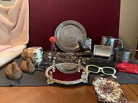 Full lot arranged on dark cloth showing all vintage jewelry, decorative figurines, accessories and trinket boxes.