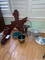 Lot on floor showing all items including driftwood wall clock, Caravelle clock, two vases, planter, Chamber Pot and candle holders.