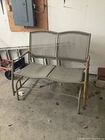 Full view of 2-seater patio swing with web seating and backrest, showing overall condition and frame design.