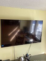 Samsung flat-screen TV mounted on wall