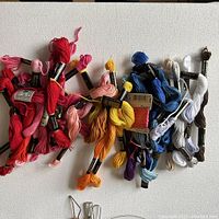 Embroidery thread skeins in various vibrant colors, all unused and in original packaging.