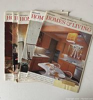 Five Ontario Homes & Living magazines stacked fanned out showing vintage mid-century modern interior covers including kitchen and living room fireplace scenes.
