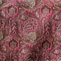 Close-up of the fabric showing the detailed paisley pattern in red and pink shades.