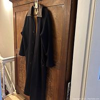 Full coat hanging on hanger showing length and overall condition