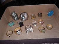 Twelve rings arranged in a cardboard tray